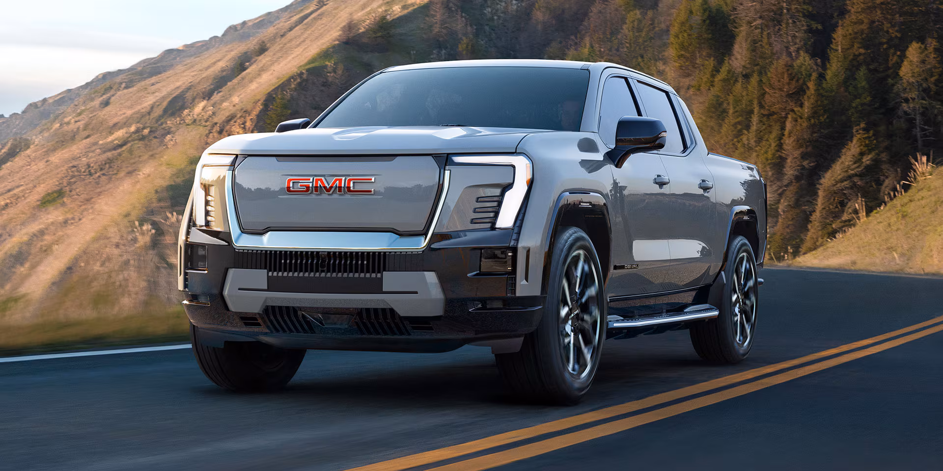 2025 GMC Sierra EV Denali Denali parked on hill at sunset